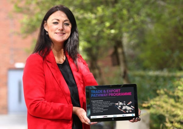 Elaine Flynn holding tablet promoting International Trade Pathway